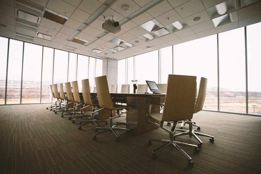 Boardroom with a long conference table and projector