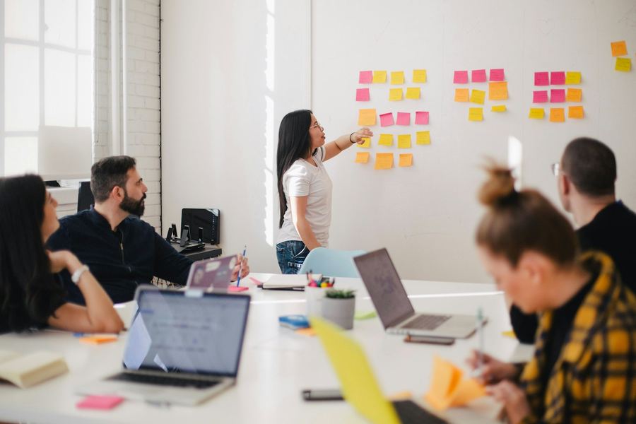 Team running a sticky-note workshop at a whiteboard wall